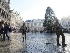  ??  ?? BRUSSELS: Soldiers and a policeman patrol on the Grand Place as the Belgian capital remains on the highest possible alert level yesterday. —AFP