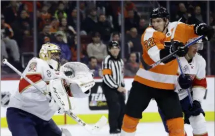  ?? MATT SLOCUM – THE ASSOCIATED PRESS ?? Panthers goalie Roberto Luongo, left, catches a puck past Flyers winger Dale Weise, center, as Alexander Petrovic defends during the second period Tuesday night at Wells Fargo Center.