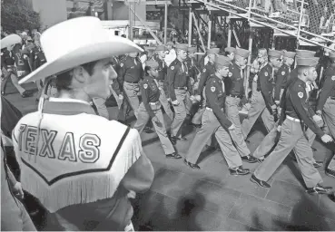  ?? JAY JANNER/AMERICAN-STATESMAN FILE ?? Texas A&M Corps of Cadets members march past the Longhorn Band ahead of the Nov. 24, 2011 Texas-Texas A&M game at Kyle Field in College Station. That's the last time the two historic rivals met in football, but all that's about to change this fall after the Longhorns join the SEC.