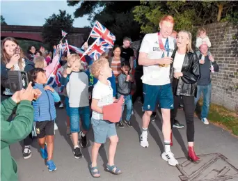  ??  ?? Maidenhead's Tom Dean arrives home with family, and girlfriend Catherine (above) after winning two Olympic gold medals in Tokyo. Ref:133695-33