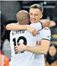  ??  ?? One start, one goal: Andy King celebrates scoring Swansea’s third with Andre Ayew