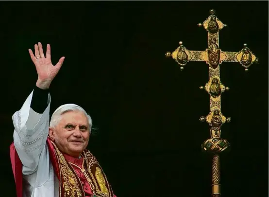  ?? PATRICK HERTZOG/AFP VIA GETTY IMAGES/FILE 2005 ?? Pope Benedict XVI waved from the balcony of St. Peter’s Basilica at the Vatican after his election as pope in 2005.