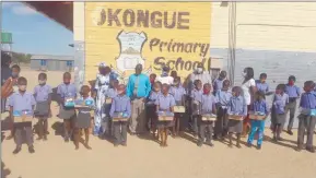  ??  ?? Capacitate­d… Principal Naholo of Otjohorong­o Primary School and learners with donated goods.