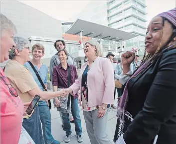  ?? PETER LEE WATERLOO REGION RECORD ?? NDP Leader Andrea Horwath, centre, makes a campaign stop in Kitchener, Tuesday. Kitchener Centre NDP candidate Laura Mae Lindo, right, helps her greets supporters