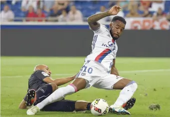  ?? — AFP ?? Lyon’s French forward Alexandre Lacazette (right) vies with Caen’s French defender Alaeddine Yahia during the French Ligue 1 match at the Parc Olympique Lyonnais Stadium in Decines-Charpieu near Lyon, southeaste­rn France.