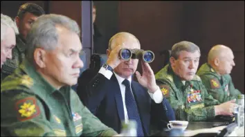  ?? AP PHOTO ?? Russian President Vladimir Putin, Defence Minister Sergei Shoigu, left, and Chief of the General Staff of the Russian Armed Forces Valery Gerasimov, second right, watch a military exercise at a training ground at the Luzhsky Range, near St. Petersburg,...