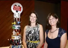  ??  ?? Ann McCarthy, left, and Christine Haas with “Classic Universal Monsters” cake by Denise and Rory Rightmyer. Below, Christy Allison and Michael Dorosh.