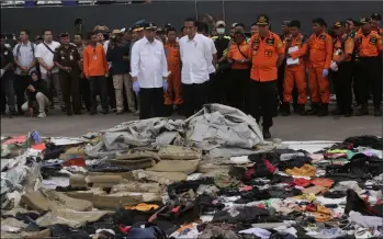  ??  ?? Indonesian President Joko Widodo (center) Transporta­tion Minister Budi Karya Sumadi (left) and Chief of National Search and Rescue Agency Muhammad Syaugi (right) inspect debris retrieved from the waters where Lion Air flight JT 610 is believed to have crashed, during their visit at the rescuers command post at Tanjung Priok Port in Jakarta, Indonesia, on Tuesday.