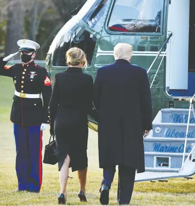  ?? MANDEL NGAN / AFP VIA GETTY IMAGES ?? Former U.S. president Donald Trump and former first lady Melania Trump make their way to board
Marine One before eventually departing for their resort property in West Palm Beach, Fla.