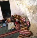  ??  ?? Ahmed Amarneh (left), and family members share a meal at his home built in cave in the village of Farasin.