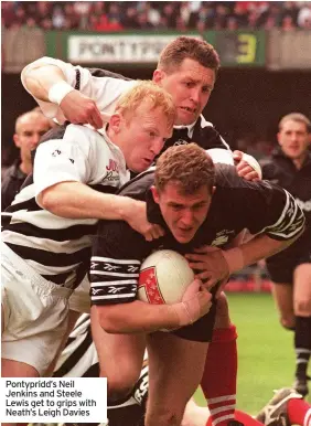  ??  ?? Pontypridd’s Neil Jenkins and Steele Lewis get to grips with Neath’s Leigh Davies