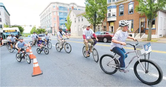  ?? AMY SHORTELL/THE MORNING CALL ?? Bicycle riders take a short ride around the block during the pedestrian safety event at the corner of Broad and New streets in Bethlehem on Wednesday. The city and the Lehigh Valley Planning Commission held the event.