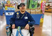  ?? ASSOCIATED PRESS ?? John Combs, a greeter in Vancouver, Wash., who has cerebral palsy, is among Walmart employees whose job will be changed to a role that’s more physically demanding.