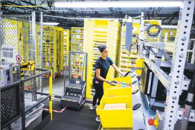  ?? Getty Images ?? An Amazon distributi­on center in February 2019 in New York City. Amazon has become Connecticu­t’s fastest growing employer, adding more than 4,000 jobs since 2016.