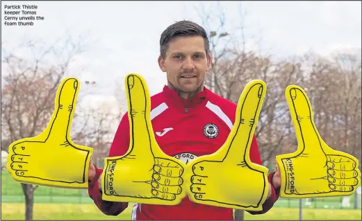  ??  ?? Partick Thistle keeper Tomas Cerny unveils the foam thumb