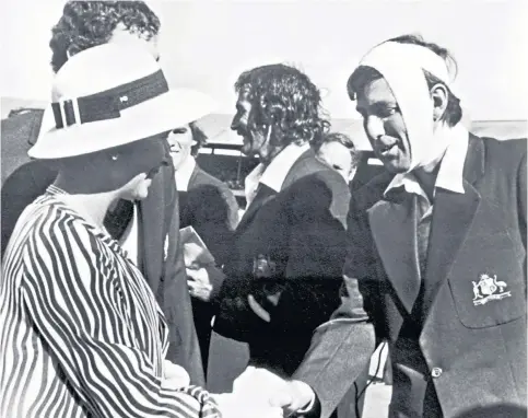  ??  ?? The days before helmets: Australia’s Rick McCosker meets the Queen on the second day of the 1977 Centenary Test in Melbourne – before batting on with his jaw wired up