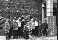  ??  ?? Clockwise from top left: Sudanese acrobats look at publicity boards at the Beijing Tianqiao Arts Performing Center; Sudanese acrobats come back to Wuhan and meet their acrobatic instructor­s; Nine acrobats from Sudan National Acrobatic Troupe with their...