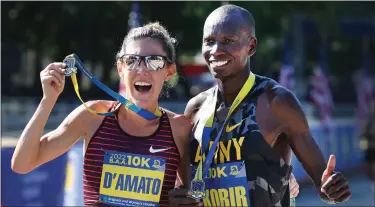  ?? NANCY LANE / BOSTON HERALD ?? Women’s winner Kiera D’amato and men’s winner Leonard Korir celebrate at the finish line of the BAA 10K on Sunday.