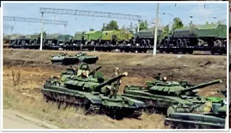  ??  ?? SHOW OF FORCE: Russian tanks mass on the border with Ukraine last week as other military vehicles arrive by train