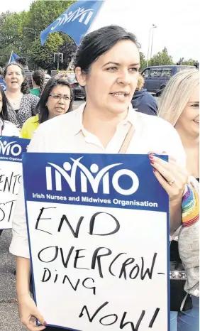  ??  ?? Nurses and midwives protesting outside Cork University Hospital yesterday. PHOTO: MICHAEL MAC SWEENEY Pressure: