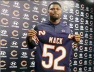  ?? TIM BOYLE — CHICAGO SUN-TIMES VIA AP ?? Newly acquired Chicago Bears player Khalil Mack displays his jersey after speaking to the media during an NFL football news conference Sunday at Halas Hall in Lake Forest, Ill.