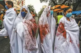  ?? Paola Mafla / AFP via Getty Images ?? Protesters pay tribute to victims of police violence in Cali. The nation has been shaken by more than a month by massive antigovern­ment protests.