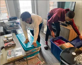  ??  ?? Morehouse College senior John Bowers and his mother, Rhetta Andrews Bowers, a state representa­tive from Dallas, Texas, pack up his belongings from his off-campus apartment on Tuesday. Bowers, Morehouse’s student government associatio­n president, has been helping fellow displaced students.