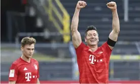  ??  ?? The Bayern Munich match-winner Joshua Kimmich (left) looks on as Robert Lewandowsk­i celebrates. Photograph: Federico Gambarini/AP