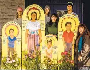  ?? BOB DAVIS ?? In January 2019, Antonia Davis, far right, stands with protesters holding portraits she created memorializ­ing people who died while in the custody of U.S. immigratio­n agents.