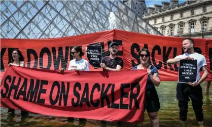  ?? Photograph: Stéphane de Sakutin/AFP via Getty Images ?? Activists protest in front of the Louvre museum in Paris last year against the museum’s ties with the Sackler family.