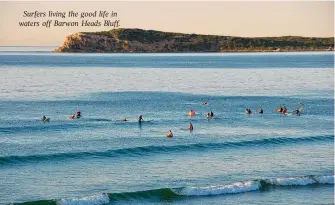  ?? ?? Surfers living the good life in waters off Barwon Heads Bluff.