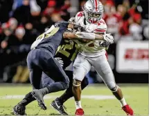  ?? MICHAEL HICKEY / GETTY IMAGES ?? Ohio State’s K.J. Hill is tackled by Purdue defenders in the Buckeyes’ 49-20 loss Oct. 20. On Saturday, Ohio State will host Nebraska, which has won its last two games.