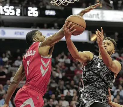  ?? Elizabeth Conley / Houston Chronicle ?? Spurs forward Kyle Anderson, right, encounters resistance from the Rockets’ Joe Johnson during a first half Monday night in which San Antonio was held to 43 points.