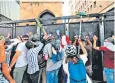  ??  ?? Protesters try to bring down a barricade in the vicinity of the Lebanese parliament