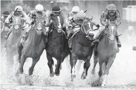  ?? ANDY LYONS/GETTY ?? Country House, ridden by jockey Flavien Prat, from left; War of Will, ridden by jockey Tyler Gaffalione; Maximum Security, ridden by jockey Luis Saez; and Code of Honor, ridden by jockey John Velazquez, fight for position in the final turn during the May 4 Kentucky Derby.