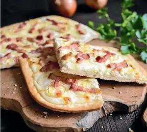  ??  ?? Flammekuec­he is an Alsatian ode to the pizza, topped with lardons, creme fraiche and onions.