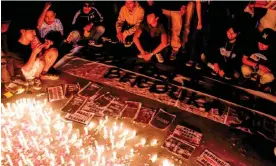  ?? Photograph: Faisal Ramadhan/Sopa Images/Rex/Shuttersto­ck ?? Indonesian football fans light candles in memory of those killed in Saturday’s disaster.