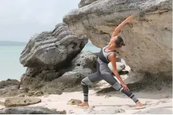  ??  ?? IN TUNE WITH NATURE: Joëlle Sleebos enjoys a yoga session at the beach.