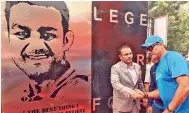  ??  ?? Ravi Shastri congratula­tes Virender Sehwag after the opening of ‘Virender Sehwag Gate’ at the Kotla on Tuesday. — BCCI