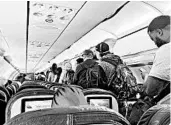  ?? VINCE WARBURTON/AP ?? Passengers exit a plane in Los Angeles. Air travel is down 90%, but cancellati­ons are creating crowded flights.