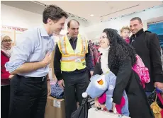  ?? NATHAN DENETTE/THE CANADIAN PRESS FILES ?? Prime Minister Justin Trudeau greets Syrian refugees at Pearson Internatio­nal Airport in Toronto last month. Trudeau is good at being cuddly, but has yet to wield the stick, Michael Den Tandt writes.