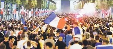  ??  ?? France fans react on the Champs-Elysees after defeating Belgium in their World Cup semi-final match in Paris, France. — Reuters photo