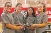  ??  ?? Olivia Kocot (from left), Mary Henning, Ailene Rodriguez and Laila Mendez pose with a robot. The girls are founding members of Made By Women, a STEM-oriented club at Von Steuben.