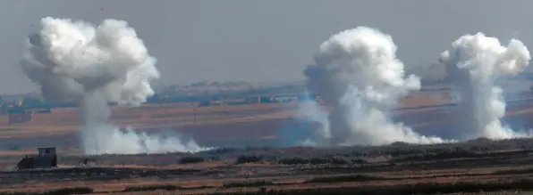  ?? Foto: Lefteris Pitarakis, dpa ?? Rauchsäule­n steigen nach einer Bombardier­ung durch türkische Streitkräf­te auf der syrischen Seite der Grenze auf.
