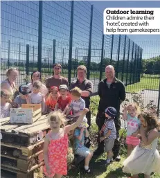  ??  ?? Outdoor learning Children admire their ‘hotel’, created with help from gamekeeper­s