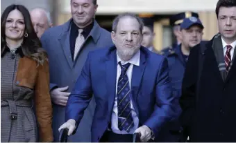  ?? AP ?? ACCUSED: Harvey Weinstein, center, leaves a Manhattan courthouse after closing arguments in his rape trial in New York, Friday.