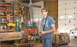  ?? Donnis Hueftle-Bullock ?? Above, Matt Ambler, an intern at Sargent Pipe in Broken Bow this summer, drills holes in flanges to be used in the well drilling process.