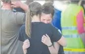  ?? JOHN ROARK — THE IDAHO POST-REGISTER ?? Students embrace after a shooting at Rigby Middle School in Rigby, Idaho, on Thursday.