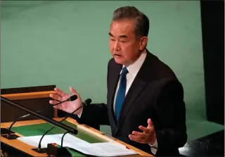  ?? AFP PHOTO ?? ‘NEGOTIATED END’
China Foreign Minister Wang Yi addresses the 77th session of the United Nations General Assembly at UN headquarte­rs in New York City on Saturday, Sept. 24, 2022 (September 25 in Manila). China on Saturday at the UN urged Russia and Ukraine not to let the effects of their war ‘spill over’ and called for a diplomatic resolution.