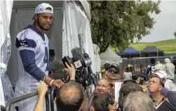  ?? GUS RUELAS/ASSOCIATED PRESS ?? Dallas quarterbac­k Dak Prescott takes questions from the media in 2018 in Oxnard, California, where the Cowboys usually hold training camp. That’s not the case this year.